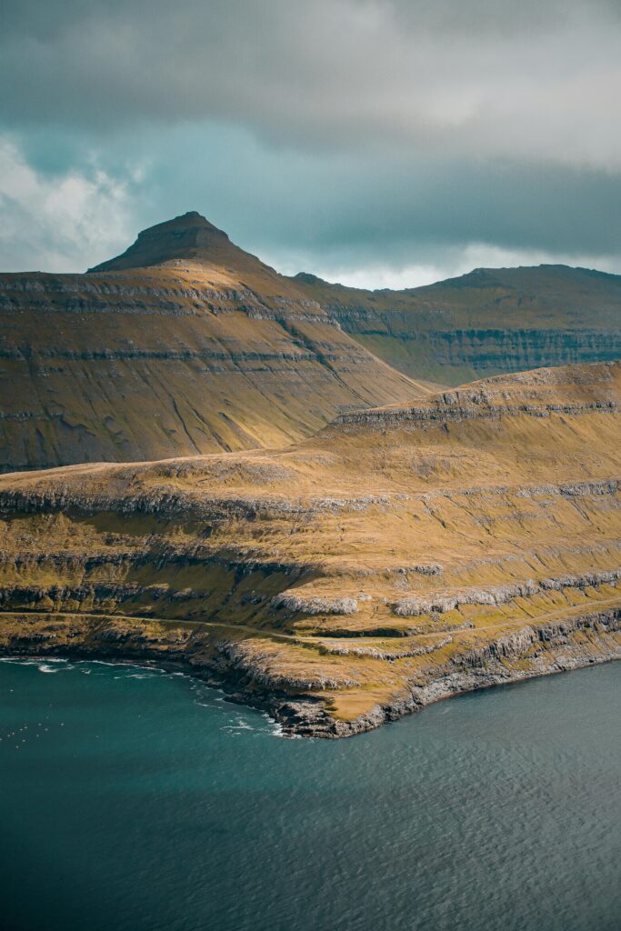 Breathtaking view of layered mountains and ocean on Faroe Islands.